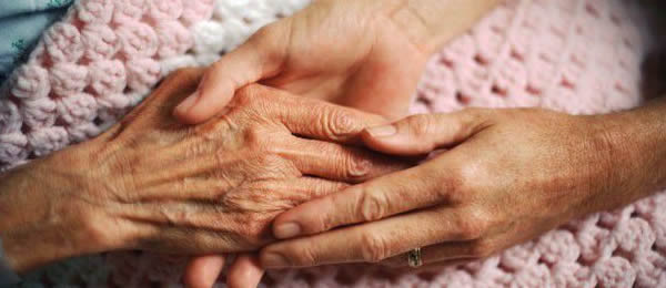 Elderly hands on a blanket