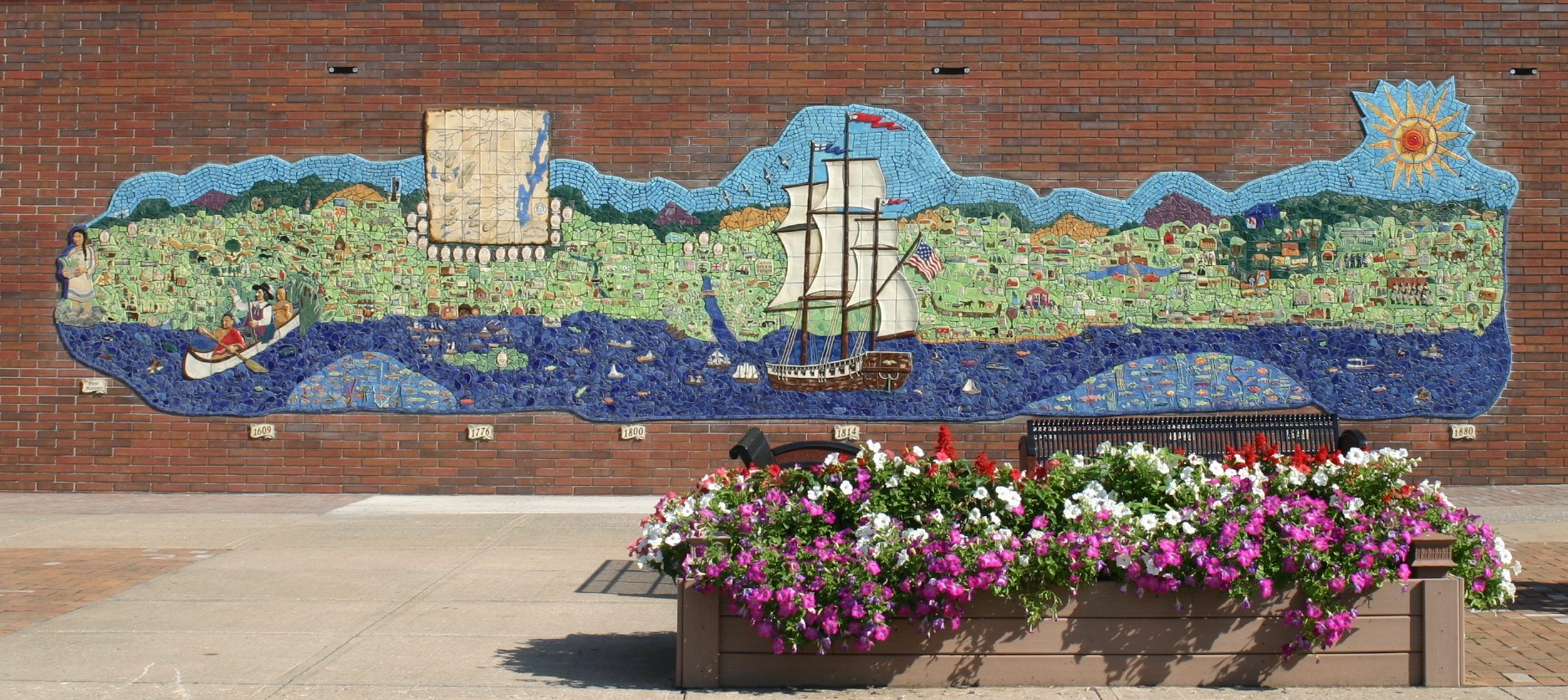 Colorful tile mosaic with history telling tiles and the side of the brick county building