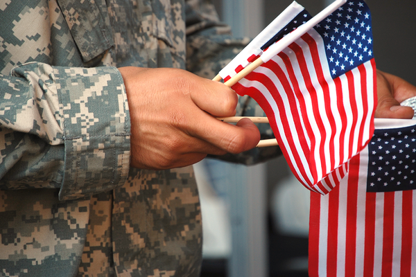 man holding flag camo military